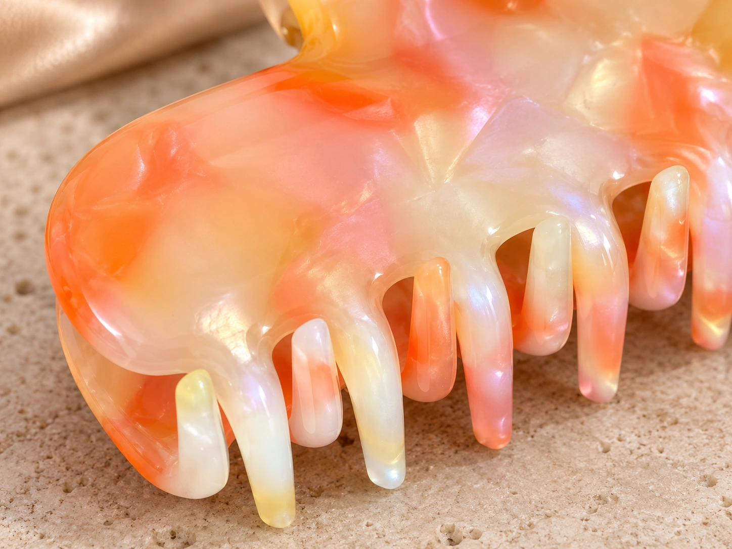 Apricot opal sculpted wave acetate claw clip, close view of the polished surface and rounded teeth, no hands
