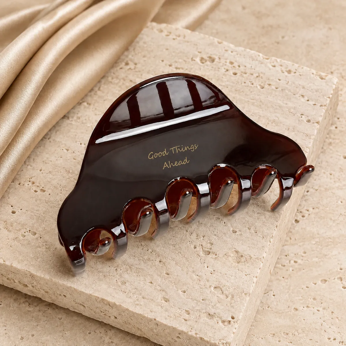 Caramel Amber arc claw clip — still life