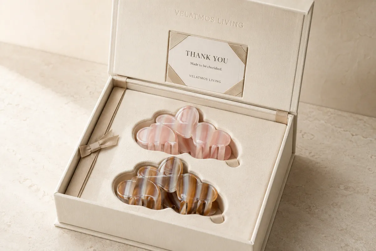 Blush Veil and Caramel Veil Amour Loop acetate claw clips in a fitted warm ivory gift box