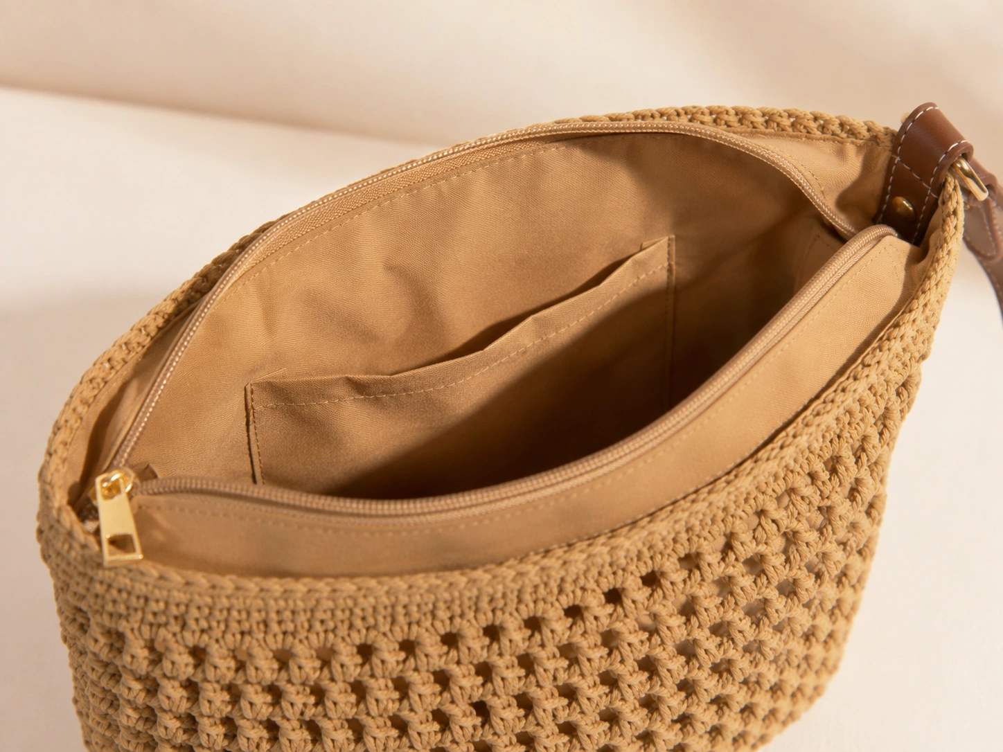 Gold-tone top zip and lined interior
